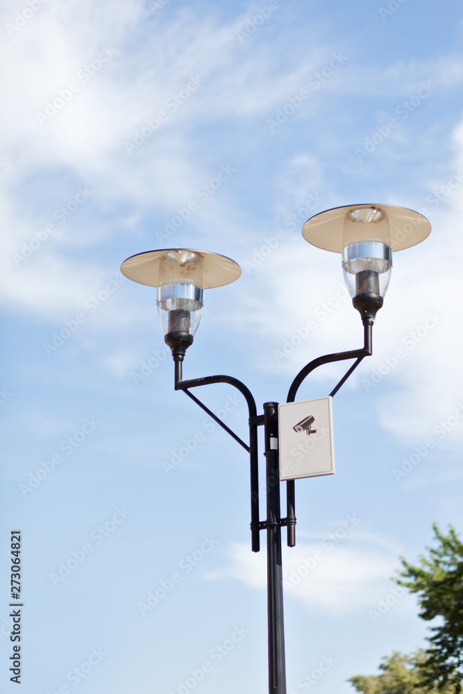 Lamppost on a cloudy sky background