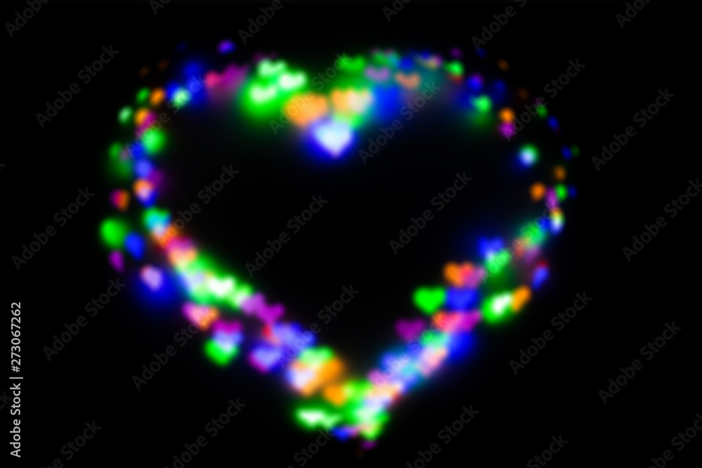 Blurred festive background with defocused colourful glitter formed a heart, bokeh in a shape of a heart. Original photographic effect. Pictures concept theme Love and St. Valentine's Day