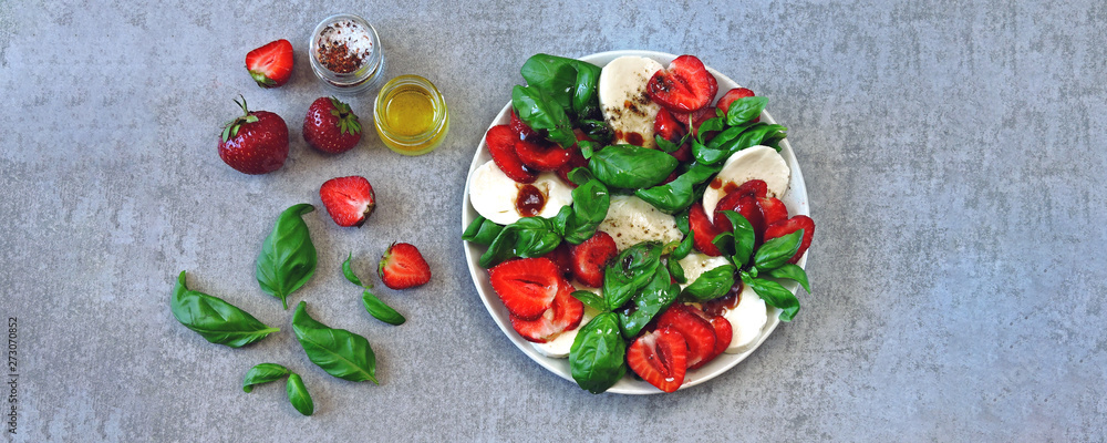 Summer caprese salad. Caprese with strawberries. Dietary salad with basil and mozzarella. Keto diet.