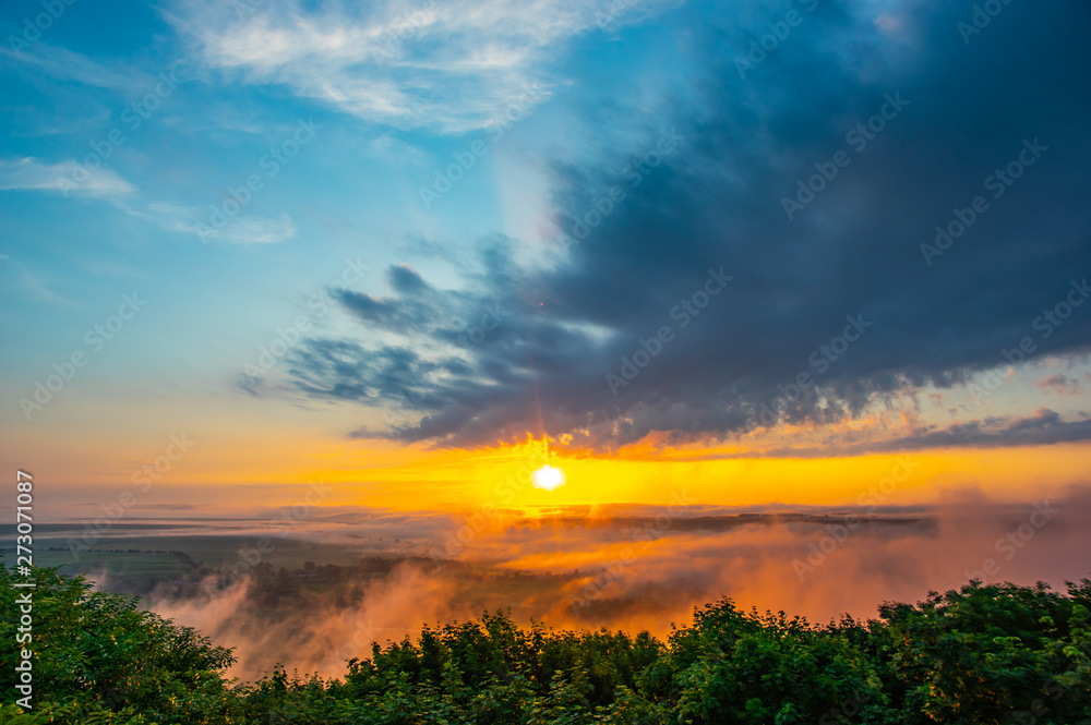 Sunrise on a foggy summer morning over the village Sunrise on a foggy summer morning over the village