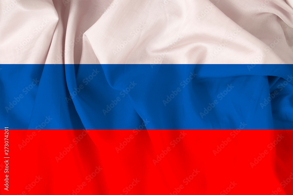 Naklejka premium beautiful national flag of Russia on soft silk with soft folds, close-up, copy space