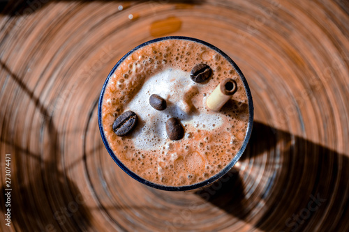 Coffee Mochachino with coffee beans and bamboo straw 