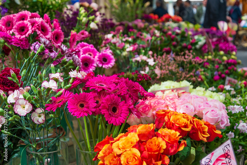 Wallpaper Mural Closeup view of colourful various flowers in vases which are sold at open air flower stall or floral shop located in outdoor market in Europe. Typical atmosphere of flower store.    Torontodigital.ca