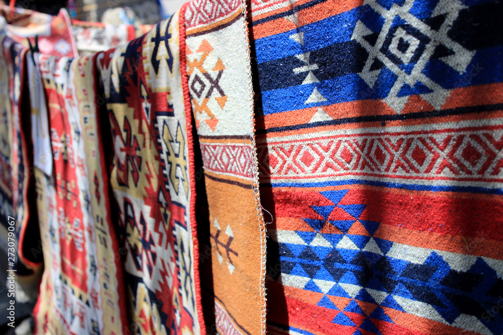 Fototapeta Hand-made carpets hanging in street market.