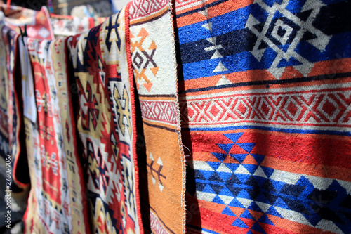 Hand-made carpets hanging in street market. photo