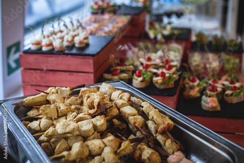 Beautifully decorated catering banquet table with assortment variety of different food snacks and appetizers on corporate christmas birthday party event or wedding celebration
