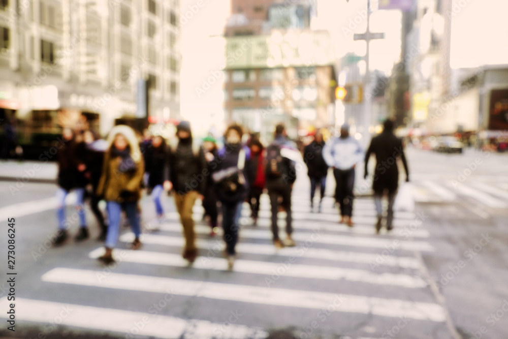 Blurry abstract background image of people walking on busy street