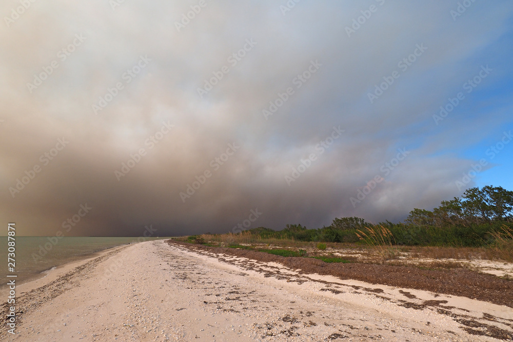 Smoke from a wildfire over the beach and Gulf of Mexico on East Cape Sable in Everglades National Park, Florida.