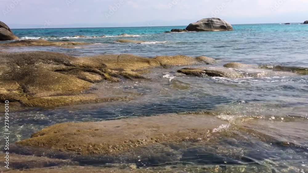 Sea and rocks. Clear water. Summer day. Cost and blue sky with clouds. Slow Motion Sea and rocks. Clear water. Summer day. Cost and blue sky with clouds. Slow Motion
