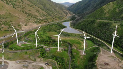 Windmill Farm wind park wind turbines Highway Truck with load Sunset Colors Farmland Field Wasatch Mountain Range Blue Skys Agriculture Farming Spanish Fork Utah Renewable Energy Cinematic USA 4K photo