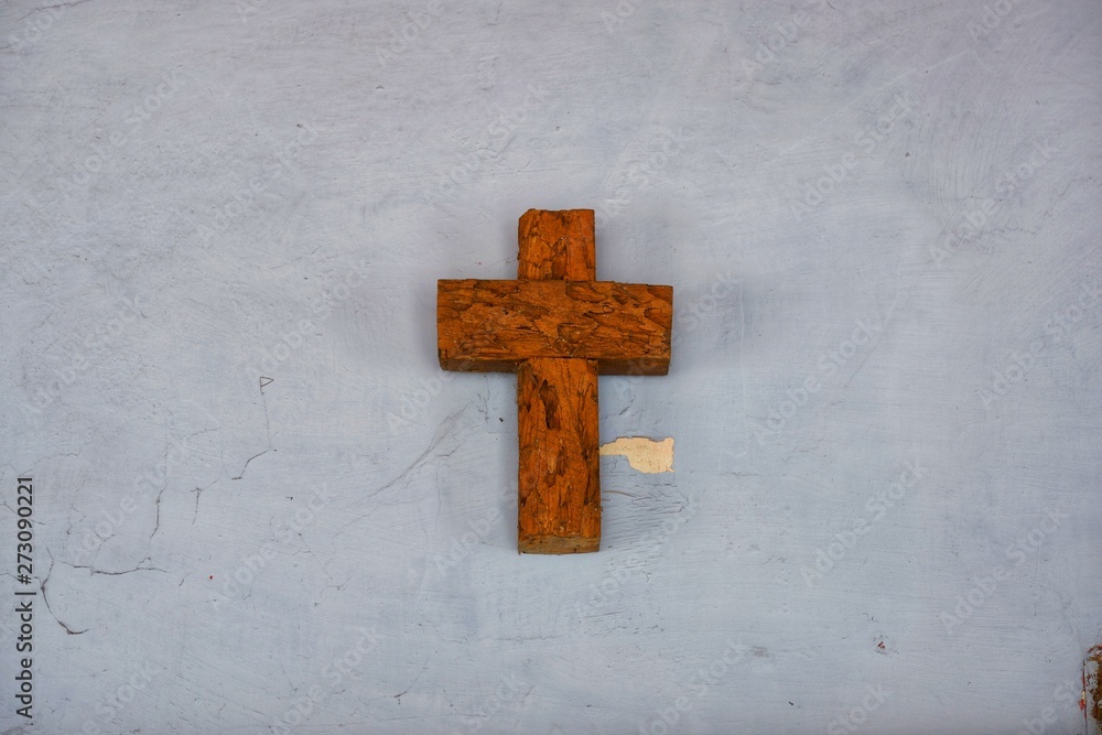 wooden cross on the white wall