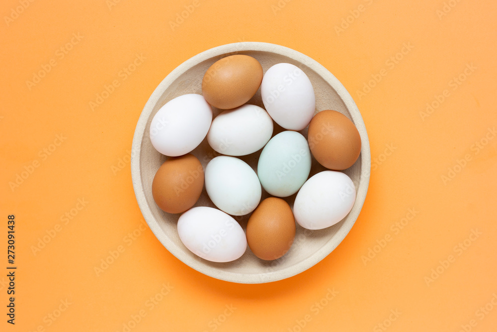 Eggs on orange background.