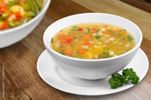 Bowl of delicious vegetables soup on table