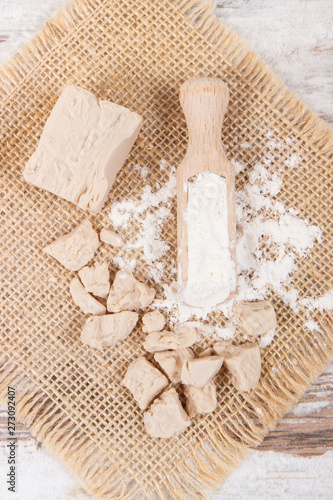 Fresh crumbled yeast and flour as ingredients for baking or cooking