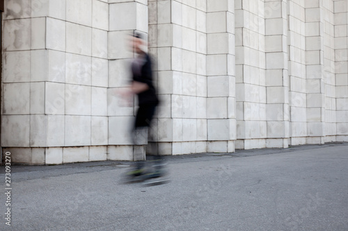 one man riding inline skates, blurry because of moving motion.