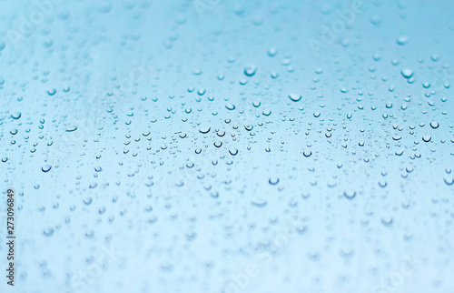 Bild auf Leinwand wet glass during rain. blue wet background