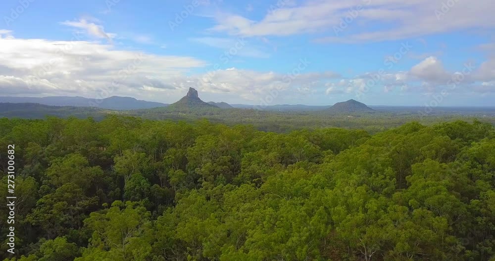 Aerial view of a tropical forest valley - mount Coonowrin and Ngungun at daytime. Glass House Mountains, Queensland, Australia. Aerial view of a tropical forest valley - mount Coonowrin and Ngungun at daytime. Glass House Mountains, Queensland, Australia.