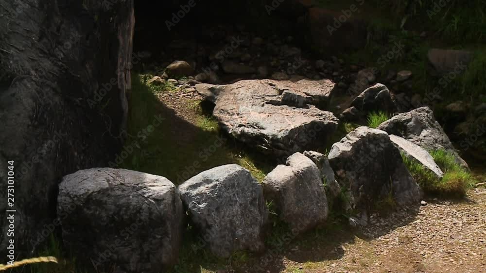 A still high angle shot of stones arranged in a semicircle around a somewhat bigger stone as the sun shines down on a warm afternoon A still high angle shot of stones arranged in a semicircle around a somewhat bigger stone as the sun shines down on a warm afternoon