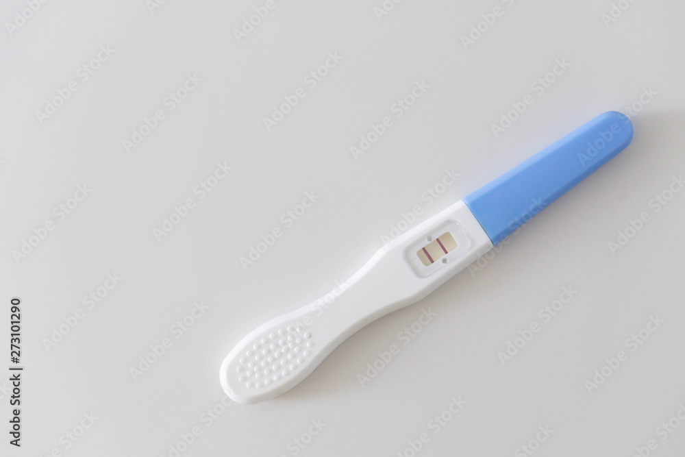Pregnancy test on white ceramic background, health care and medical concept Pregnancy test on white ceramic background, health care and medical concept