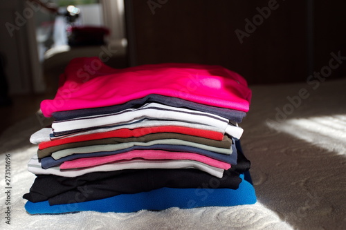 Colorful clothes on the bed in the sunlight