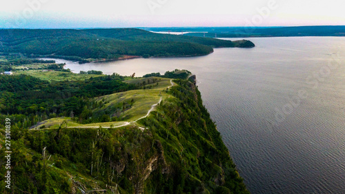 Arial view of Zhiguli mountains with green trees and Volga river in Samarskaya Luka national park during summer evening, Samara region, Russia