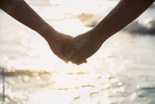 Asian couple is holding hand near to the sea