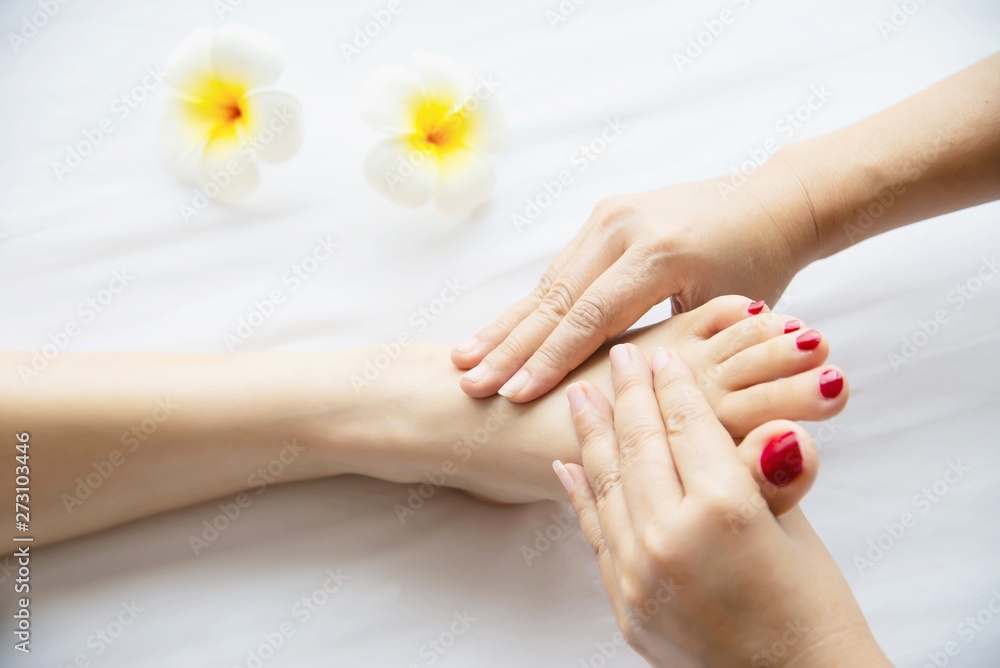 Woman receiving foot massage service from masseuse close up at hand and foot - relax in foot massage therapy service concept