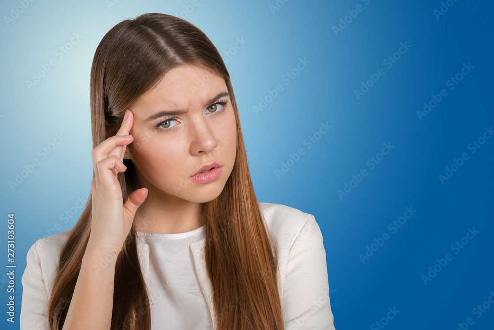 A young woman with a headache holding head A young woman with a headache holding head