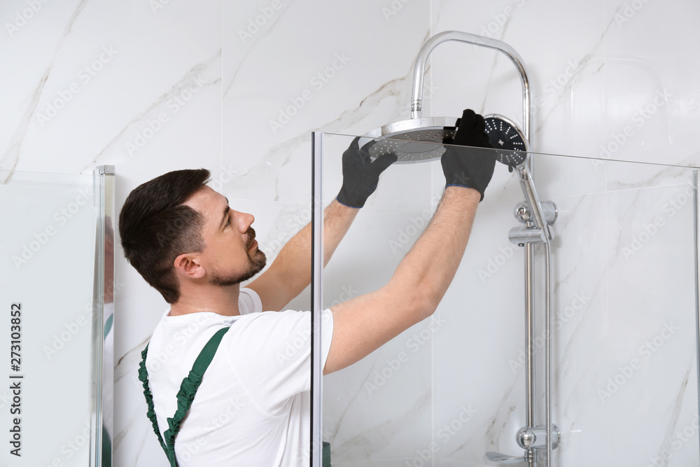 Professional handyman working in shower booth indoors - obrazy, fototapety, plakaty 