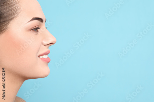 Portrait of young woman with beautiful face and natural makeup on color background, closeup. Space for text