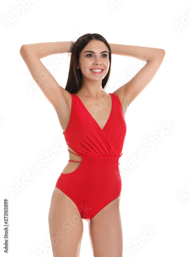 Portrait of attractive young woman with slim body in swimwear on white background