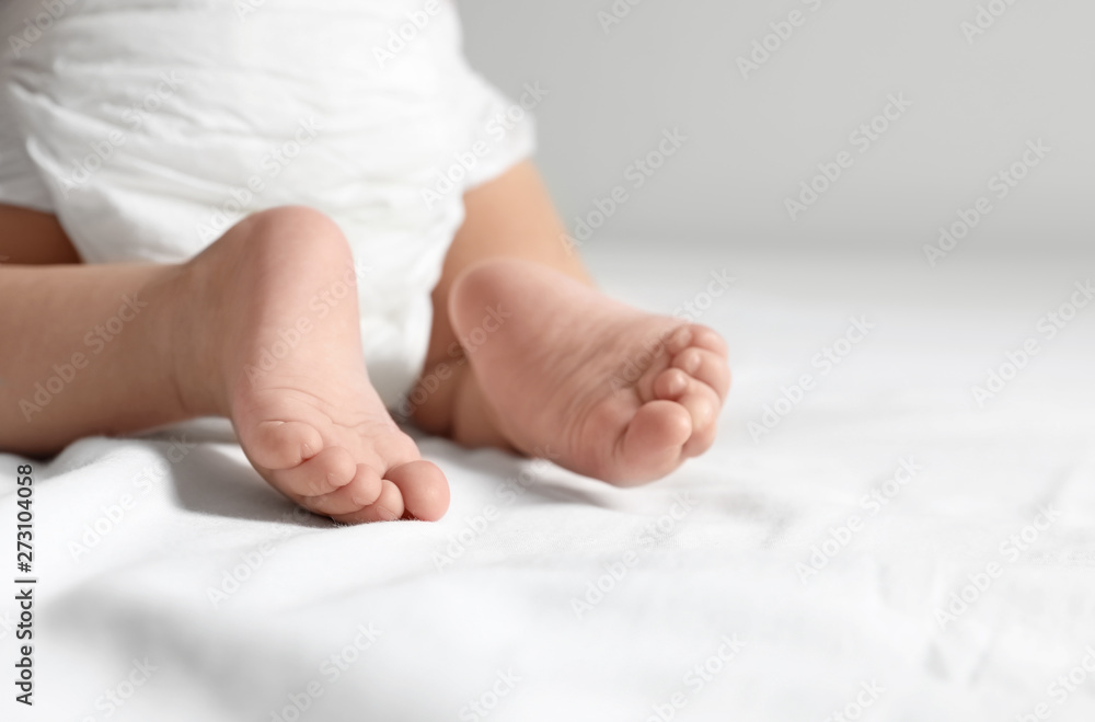Cute little baby crawling on white bed sheet, closeup. Space for text Cute little baby crawling on white bed sheet, closeup. Space for text