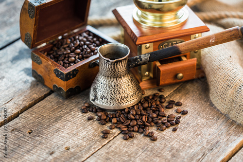 Turkish coffee concept. Copper coffee pot, vintage coffee grinder, coffee beans