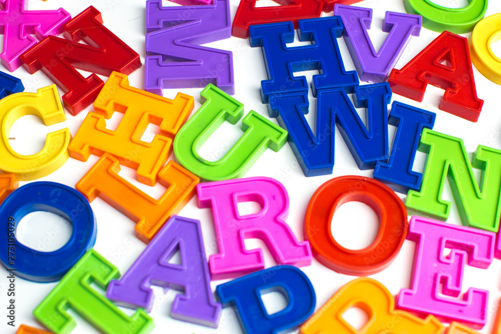 Fototapeta premium Heap of plastic colored alphabet letters close up.