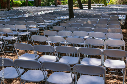 White plastic chairs set up an outdoor in row before ceremony  event or party