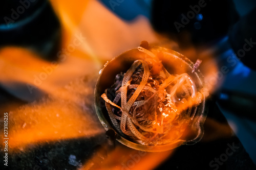 smelting precious metal of silver or gold. remelting of jewelry in a crucible with a torch at a jeweler’s workplace. jewelry making