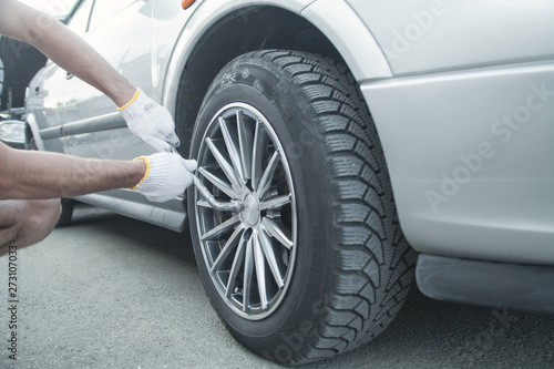 Changing car tire. Car service. Tire installation concept