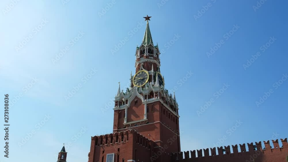 The clock on Spasskaya Tower of the Kremlin against the blue sky on a sunny summer day. Sight of Moscow, the capital of Russia. Red Square, City center, tourist place. World famous symbol of Russia. The clock on Spasskaya Tower of the Kremlin against the blue sky on a sunny summer day. Sight of Moscow, the capital of Russia. Red Square, City center, tourist place. World famous symbol of Russia.
