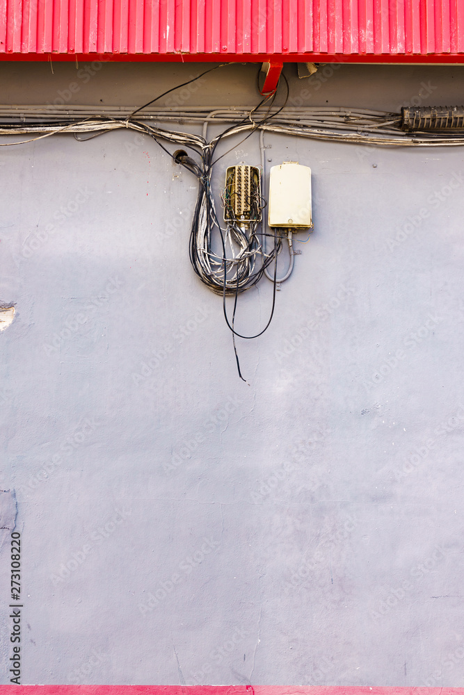 Cable power cords in tangled mess on wall outdoor Cable power cords in tangled mess on wall outdoor