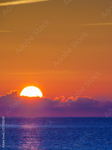 Sunrise or sunset over sea surface