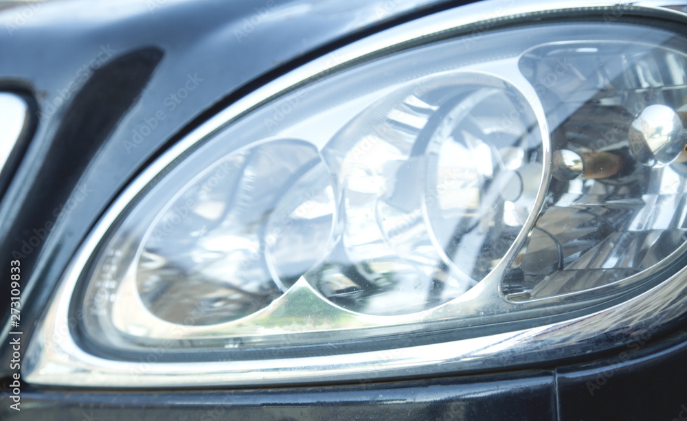 Close up photo of a car headlight.