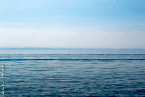 Lake Baikal on a sunny day. Clear blue sky and water. Free space for text. Background for design, screen saver