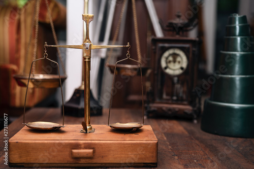 Many kind of old fashioned balance scales on wooden table. Colorful ancient balance scales in vintage background, isolated. the symbol of Lawyer. Royalty high quality free stock image.