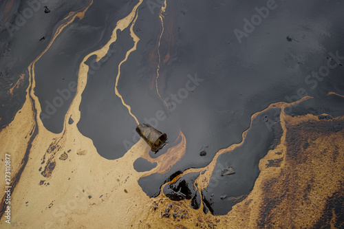 Oil sludge contaminating the sea during the oil spill disaster in Samet Island, Rayong, Thailand.