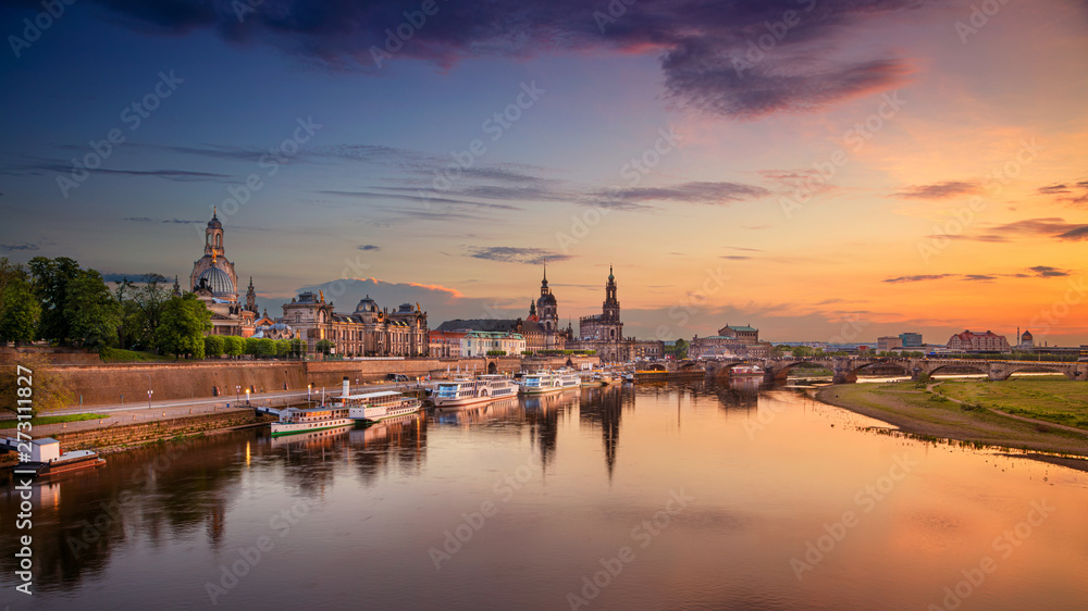 Dresden, Germany. Panoramic cityscape image of Dresden, Germany with reflection of the city in the Elbe river, during sunset.