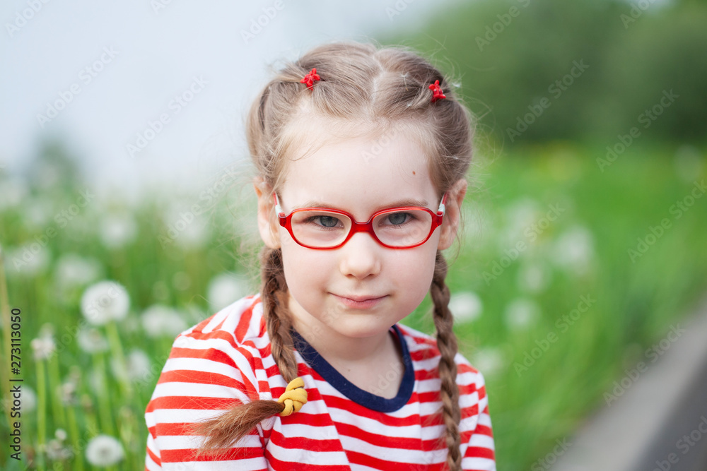 beautiful emotional girl with glasses playing with dandelions. childhood concept beautiful emotional girl with glasses playing with dandelions. childhood concept