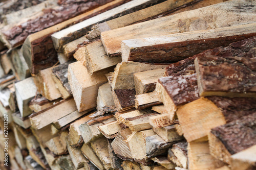 Beautiful countryside view of timber firewood stacked in a big stack near home in a countryside village home. 