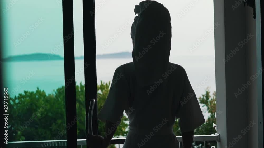 girl in a bathrobe overlooking the ocean girl in a bathrobe overlooking the ocean