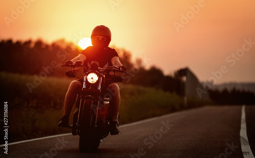 Man on motorcycle rides the route during sunset.