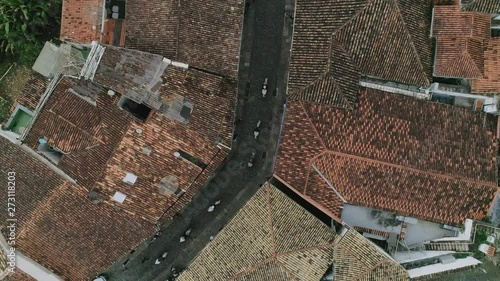 Drone footage of a gorup of horses croosing the streets of a city, minas gerais, Brazil. photo